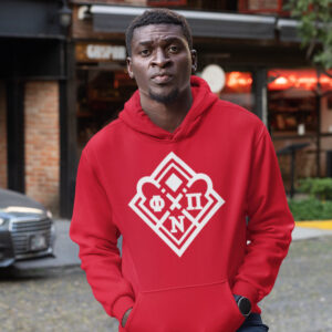 A young man standing on a busy street wearing the Phi Nu Pi Diamond Hoodie.