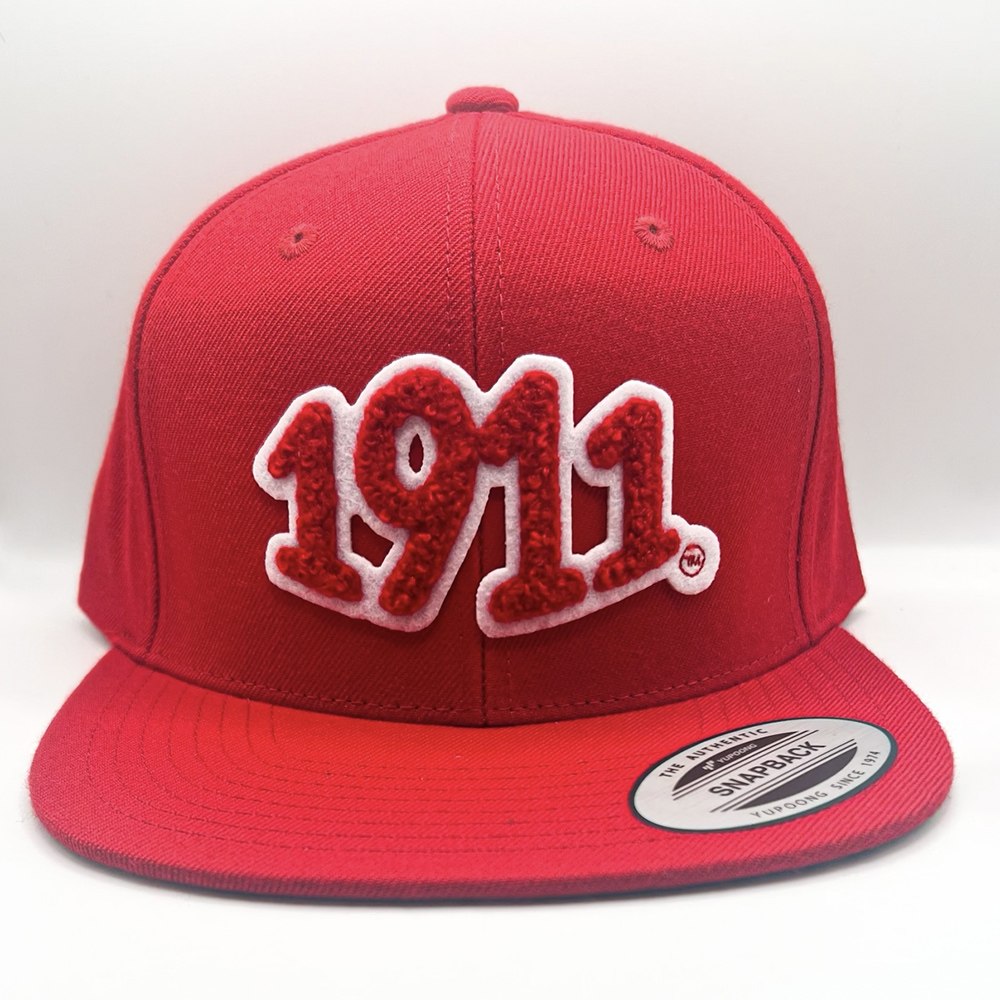1911 chenille patch on red snapback.